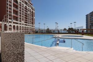 a swimming pool in the middle of a building at Ferrobus Duplex in Cullera