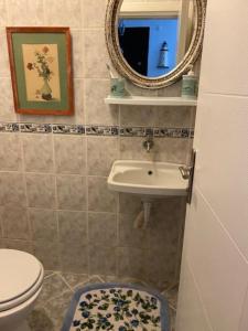 a bathroom with a sink and a toilet and a mirror at Cheerful Bodrum Home in Bodrum City