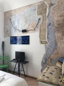 a room with a desk and a computer on a wall at L'Acanto in Syracuse