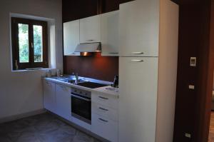 a kitchen with white cabinets and a sink at Buonincontro Apartment in Florence
