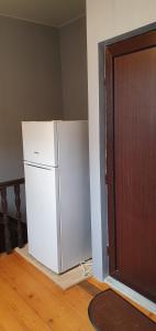 a white refrigerator in a room next to a door at Number 9 in Tbilisi City