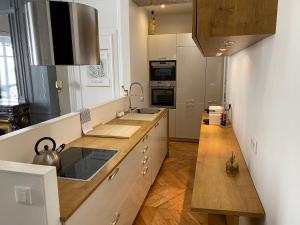 a kitchen with a sink and a stove top oven at Beautiful 3BR Apt in Lyon Center in Lyon