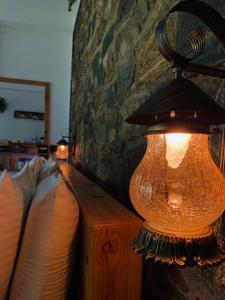 a lamp sitting on top of a wooden table at The Symbol of Ella in Ella