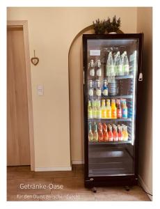 un frigorifero aperto pieno di bevande di Hotel Pension garni Haus am Strand 2 a Norddeich