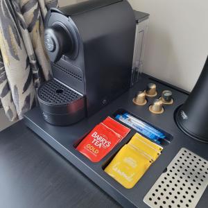 a desk with a computer with batteries and other items at Dun Maeve Guesthouse in Westport