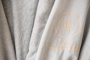 a close up of the hufür heritage logo on a curtain at Hotel Hartness in Greenville