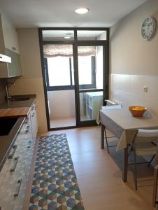 a kitchen with a table and a dining room at A Devesa in Redondela