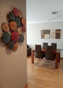 a dining room with a wall mural of umbrellas at A Devesa in Redondela