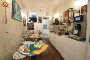 a room with two tables and a counter in a kitchen at Amélie Hotel in Paris +92 photos