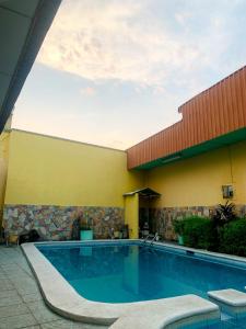 a swimming pool in front of a building at Hotel Continental Plaza in San Miguel