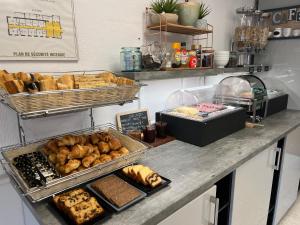 a bakery counter with various types of bread and pastries at Hôtel Le Mirage in Saintes-Maries-de-la-Mer