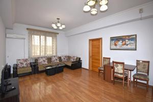 a living room with a couch and a table and chairs at Argishti Street, 2 bedrooms Comfortable apartment GL152 in Yerevan