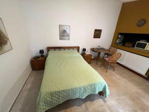a bedroom with a bed and a table and chairs at Linda casa en Barra de Carrasco in Montevideo