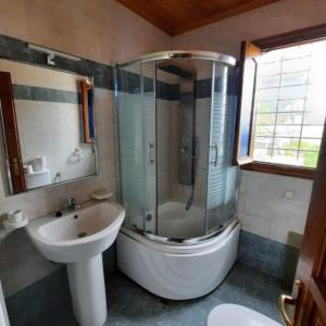 a bathroom with a shower and a sink and a toilet at Milea Byron House Tsagarada in Tsagarada +13 photos