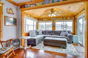 a living room with a couch and a table at Lime Lake Cottage with Lakefront Deck and Dock! 