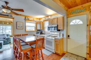 a kitchen and dining room with a table and chairs at Lime Lake Cottage with Lakefront Deck and Dock! 