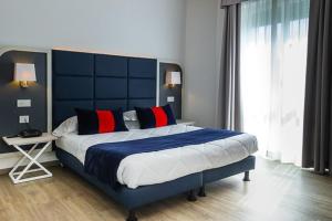 Letto o letti in una camera di Hotel Rombino