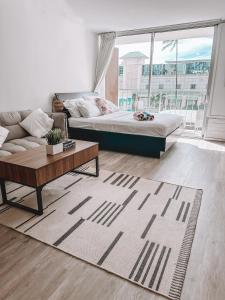 a living room with a bed and a coffee table at Modern Studio - Heart of Waikiki with Parking! in Honolulu