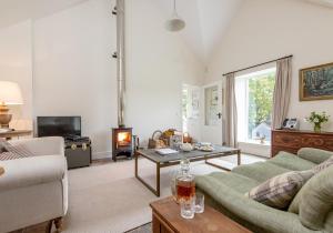 a living room with a couch and a table at The Kennels in Ballogie