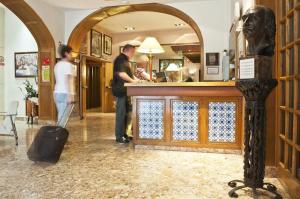 
a woman standing in front of a counter in a room at Duran Hotel & Restaurant in Figueres
