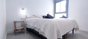 a bedroom with a large white bed with a window at Panorama Beach - Sea Breeze Apartment in Torrox Costa +17 photos