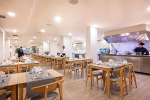 a restaurant with tables and people working in the kitchen at GF Noelia in Puerto de la Cruz