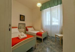 a bedroom with two beds and a window at Calaluna - Villa Sea View by Diddoi in Leuca