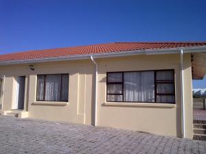 a small house with a red roof at Port Elizabeth Apartment in Port Elizabeth