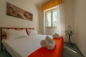 a bedroom with a bed with towels on it at Calaluna - Villa Sea View by Diddoi in Leuca