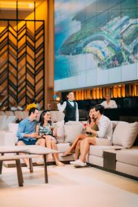 a group of people sitting on couches in a room at Barceló Maya Riviera - All Inclusive Adults Only in Xpu Ha