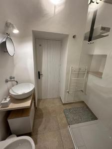 a bathroom with a toilet and a sink and a shower at Trullo Gnoffa in La Correggia