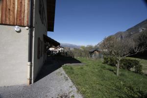 a view from the side of a house with a grass field at Lac et Montagne in Faverges