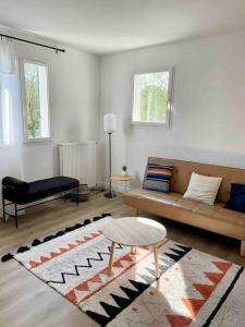 a living room with a couch and a table at Marne la Vallée Apartment in Serris