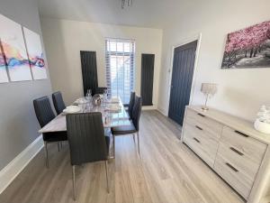 a dining room with a table and some chairs at Edith Haven Tynemouth Fabulous Coastal Holiday Home in Tynemouth