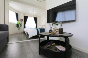 a living room with a television on a wall at ELLE Namba 6 in Osaka