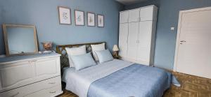 a bedroom with a bed with a mirror and a dresser at 5munutes from the airport & 15 from the City center in Sofia