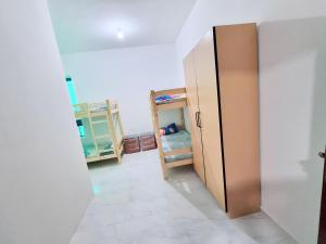 a room with a locker and a bunk bed at Abu Dhabi Center - Unique Bed Space in Abu Dhabi