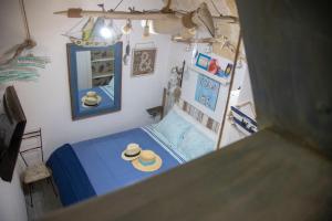 a bedroom with a blue bed with a hat on it at You & Me in Polignano a Mare