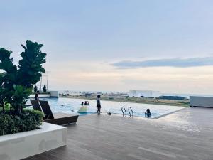 a group of people playing in the water in a pool at New l 2BR I 2-6Pax I Jonker 5 Min I SeaView I AmberCove in Melaka