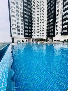 a large swimming pool with tall buildings in the background at New l 2BR I 2-6Pax I Jonker 5 Min I SeaView I AmberCove in Melaka