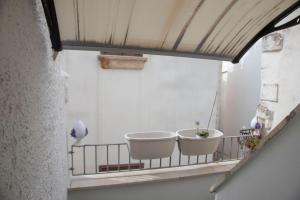 two tubs on a balcony in a building at You & Me in Polignano a Mare