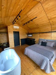 a bedroom with a bed in a wooden cabin at Nordic Cabanas in Cambara do Sul