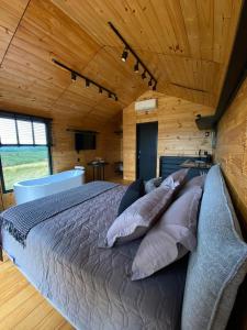 a bedroom with a bed with pillows on it at Nordic Cabanas in Cambara do Sul