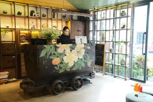 a woman standing behind a counter in a store at Deja Vu House Ha Long in Ha Long