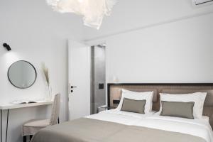 a bedroom with a large bed and a mirror at Icos City 2 in Hersonissos
