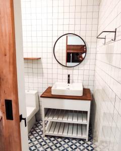 a bathroom with a sink and a mirror at Awana Farmhouse Dieng in Dieng