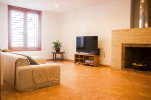 a living room with a couch and a fireplace at N28 in Xàtiva