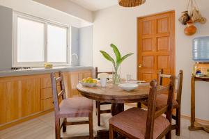 a kitchen with a wooden table and chairs in a kitchen at Suites Parador Santo Domingo de G. in Oaxaca City