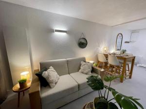 a living room with a couch and a table at Le Studio de la Digue in Wissant