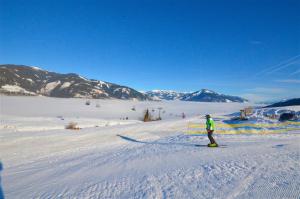 a person is skiing down a snow covered slope at Ski-in Ski-out Chalet Maiskogel 17A - by Alpen Apartments in Kaprun